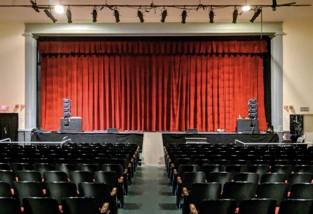 The Odeum stage with red curtain